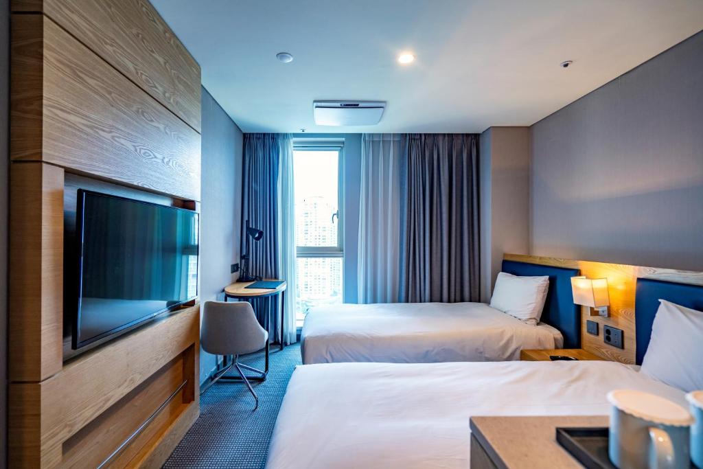 Postel nebo postele na pokoji v ubytování Centum Business Hotel