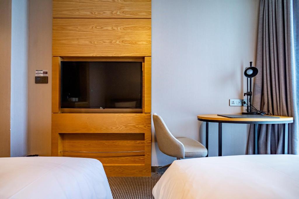Postel nebo postele na pokoji v ubytování Centum Business Hotel