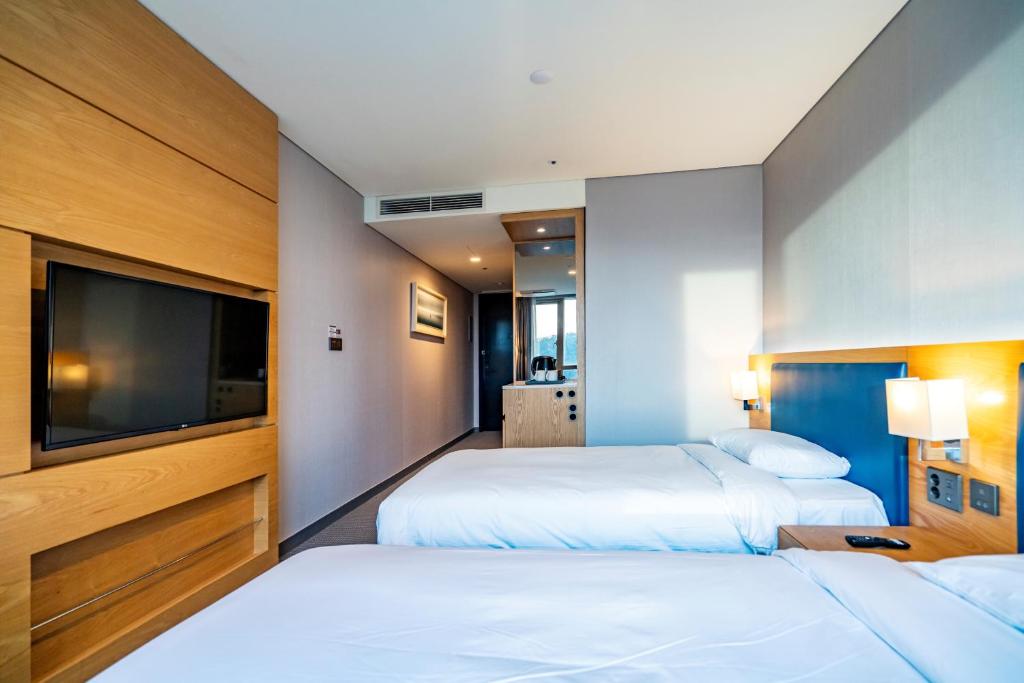 Postel nebo postele na pokoji v ubytování Centum Business Hotel