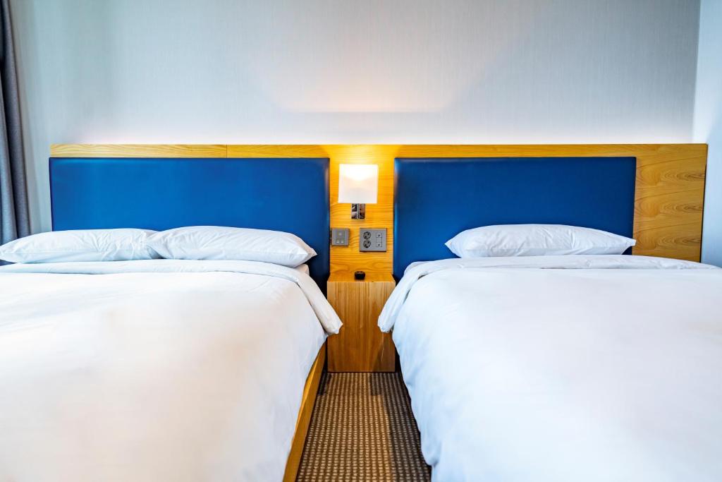 Postel nebo postele na pokoji v ubytování Centum Business Hotel