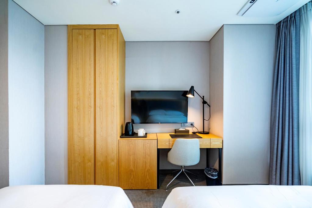 Postel nebo postele na pokoji v ubytování Centum Business Hotel