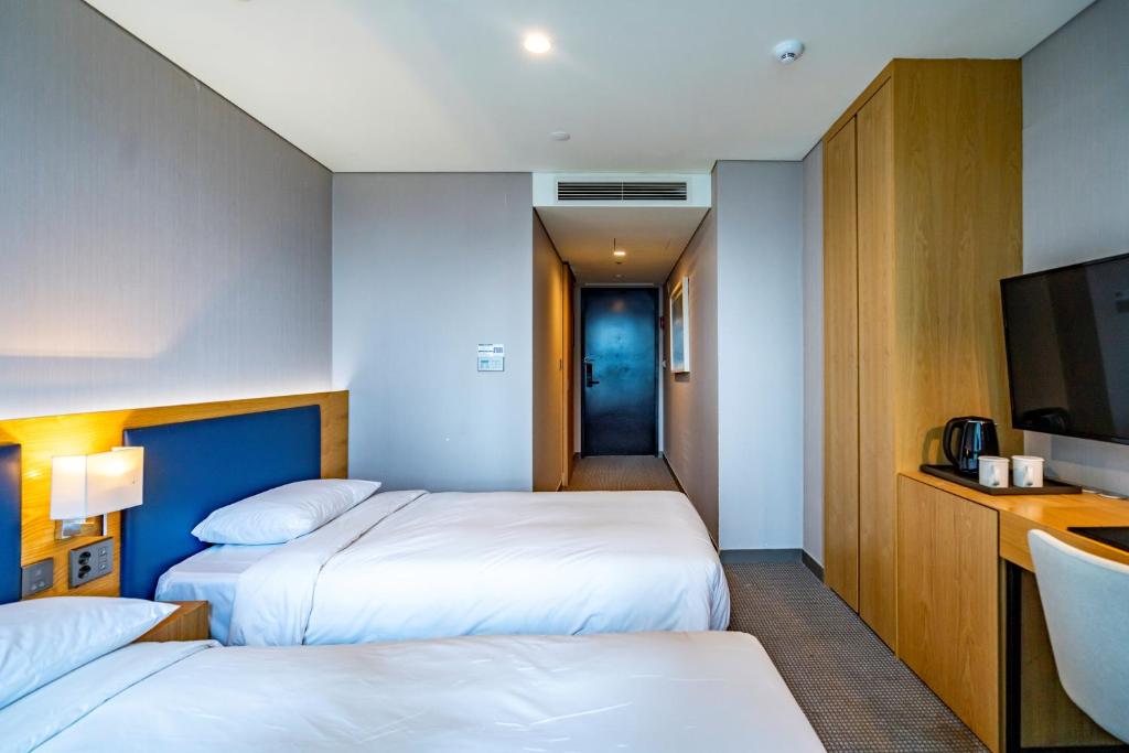 Postel nebo postele na pokoji v ubytování Centum Business Hotel