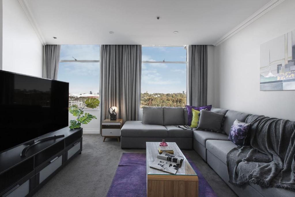 - un salon avec un canapé et une télévision dans l'établissement Grand Luxury in the CBD along the Yarra River, à Melbourne