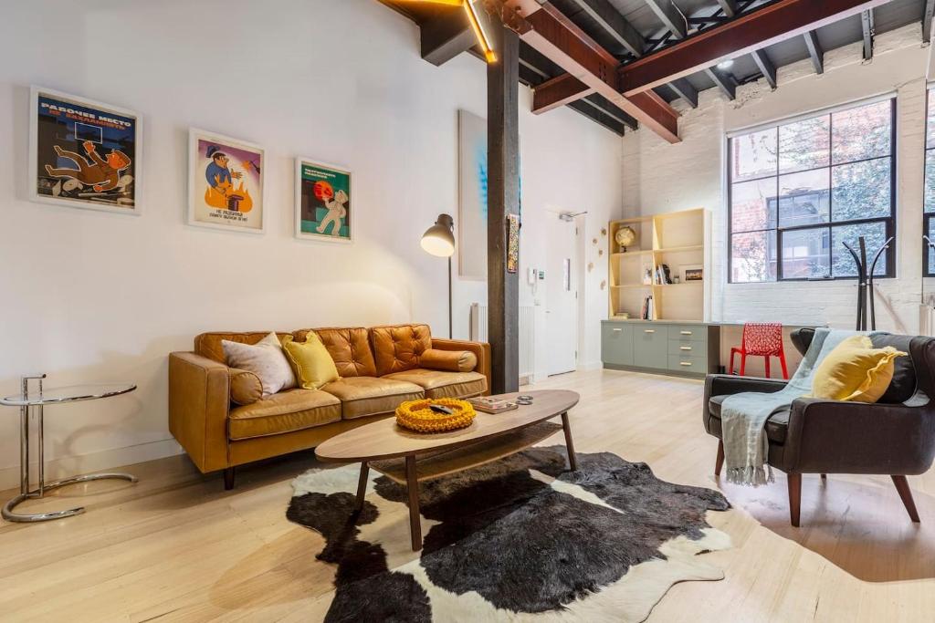 a living room with a couch and a table at Fitzroy Thrills in MacRobertson Factory Conversion in Melbourne
