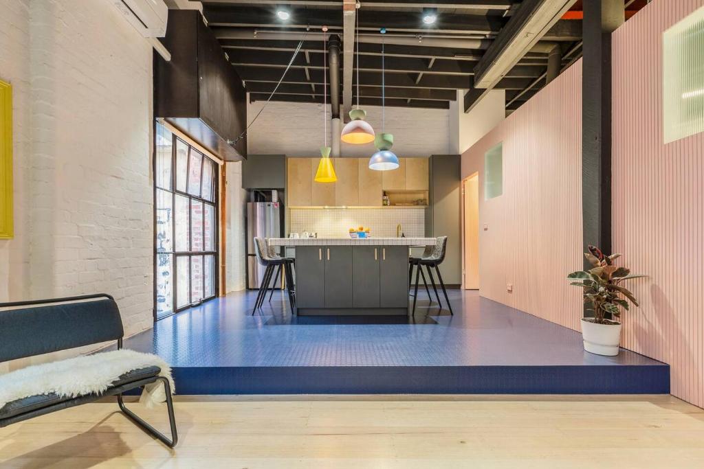 an empty room with a blue floor in a building at Fitzroy Thrills in MacRobertson Factory Conversion in Melbourne
