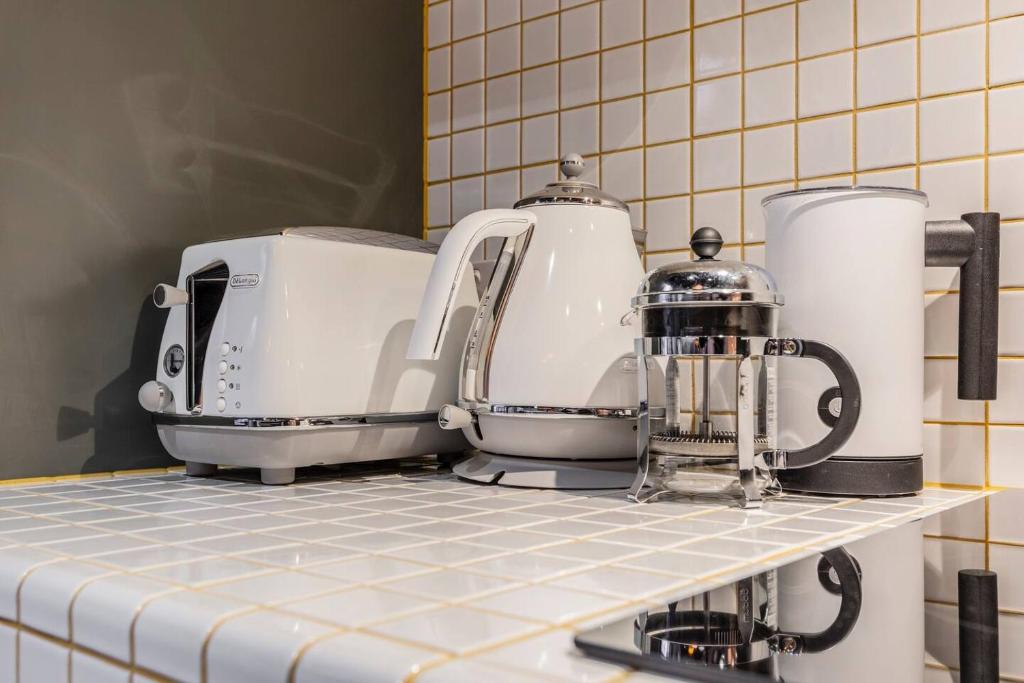 a kitchen counter with two toasters on a shelf at Fitzroy Thrills in MacRobertson Factory Conversion in Melbourne