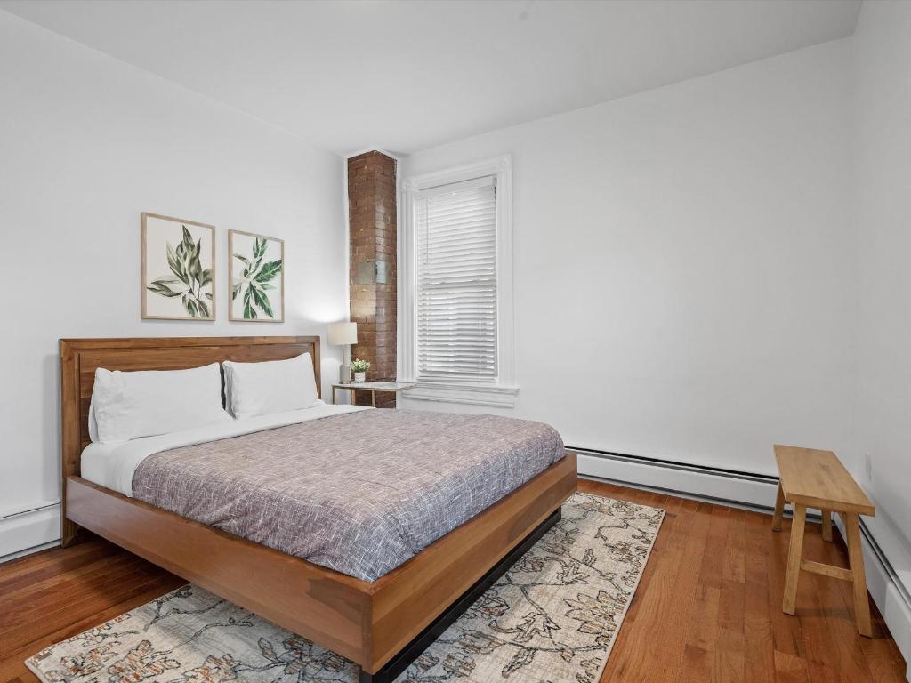 a bedroom with a bed and a window at Shadyside, Pittsburgh, Modern and Cozy 1 Bedroom Unit3 with Free Parking in Pittsburgh