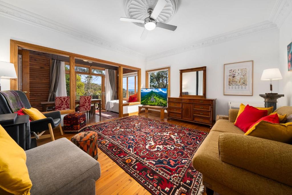a living room with a couch and a rug at Banksia Tops in Leura