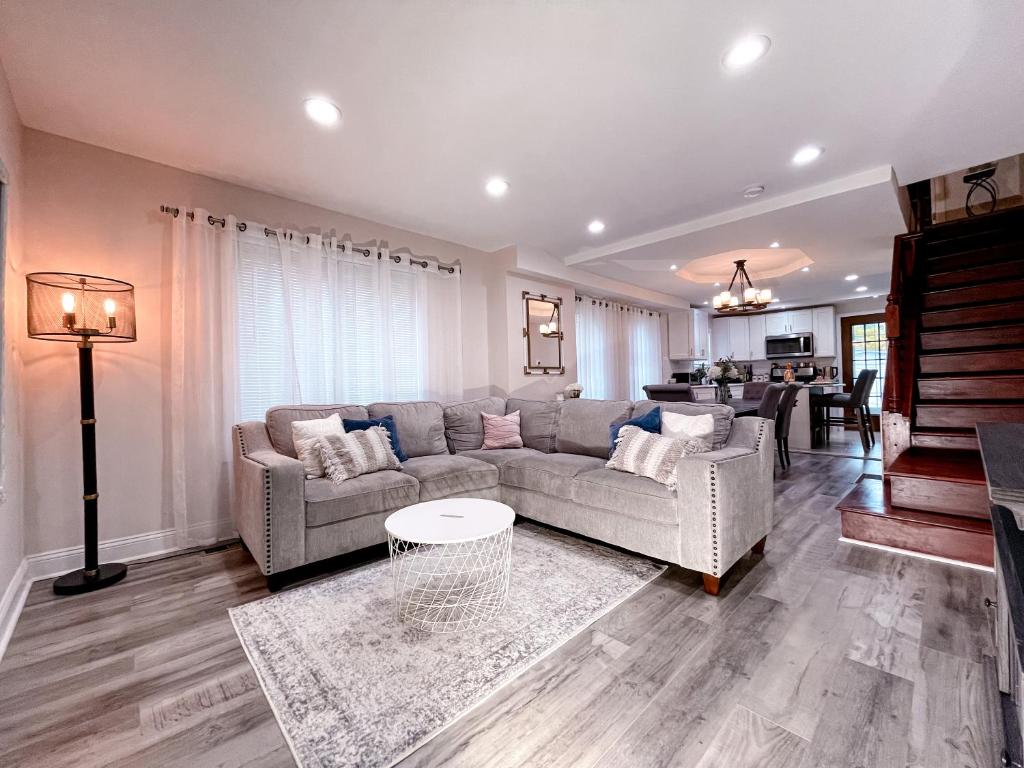 a living room with a couch and a table at Cheerful & Modern Home w/ a Walkout Deck Area in Glenside