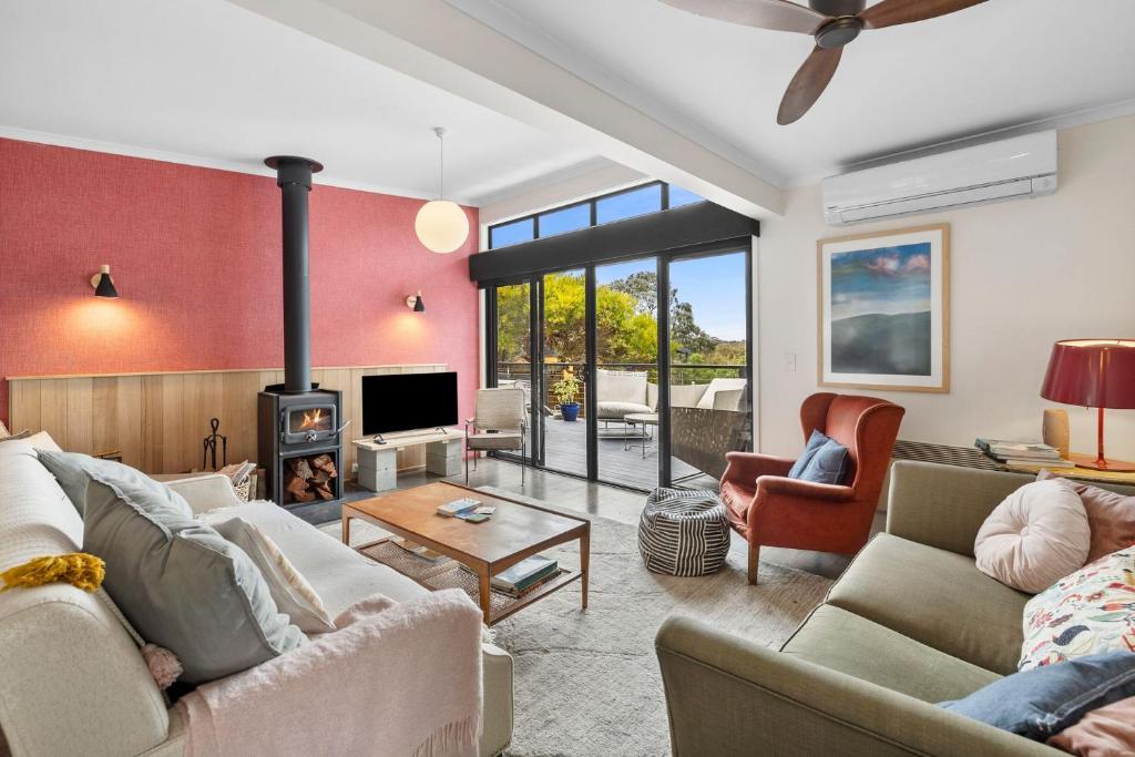 a living room with a couch and a fireplace at Blue Haven at Aireys in Aireys Inlet