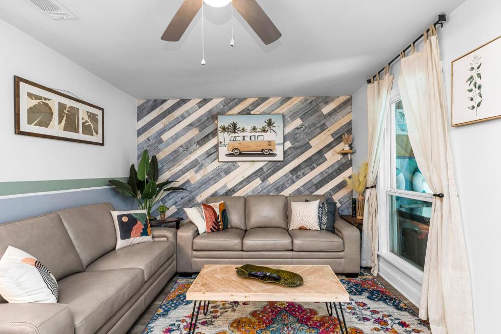 a living room with a couch and a table at Boho Bungalow in Panama City Beach