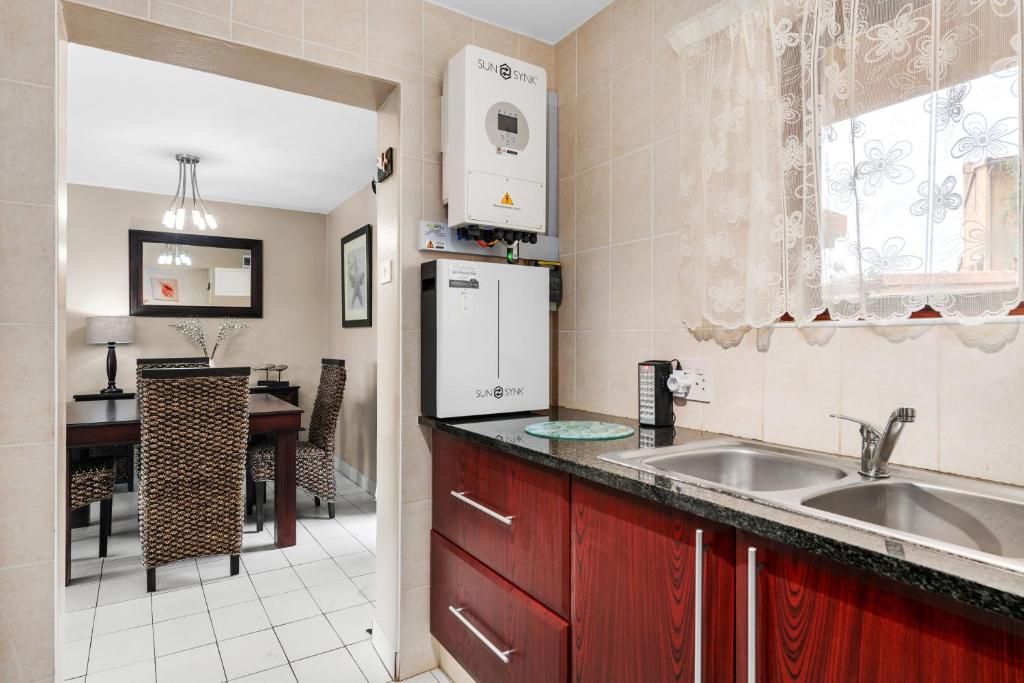 a kitchen with a sink and a dining room at San Lameer Villa 2826 - 2 Bedroom Classic - 4 pax - San Lameer Rental Agency in Southbroom