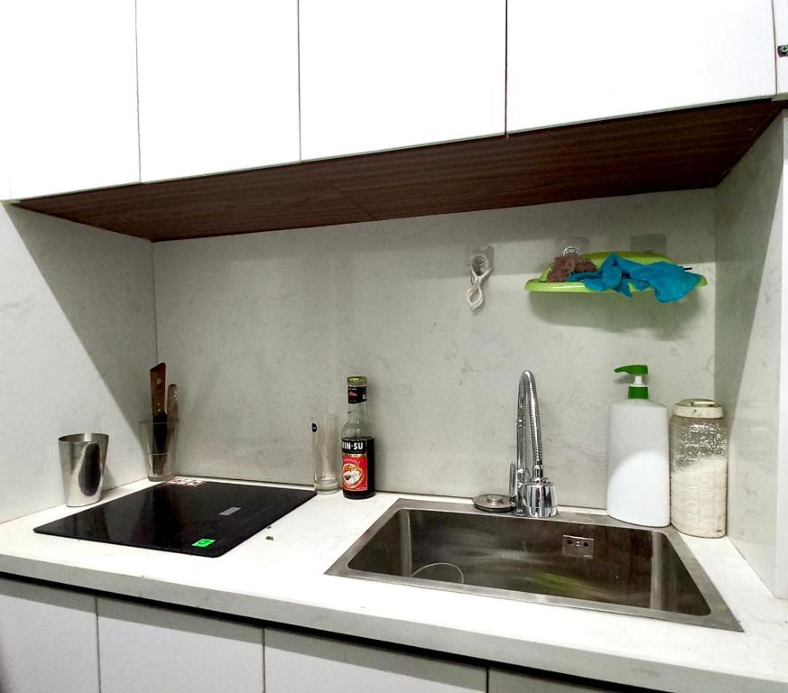 a kitchen counter with a sink and a counter top at Amelié Homestay in Hanoi