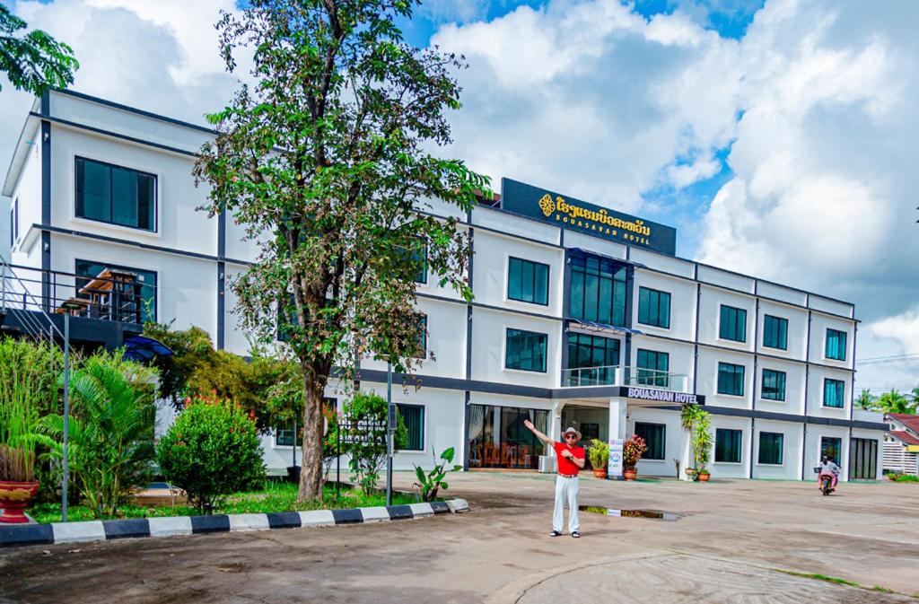 a man standing in front of a building at Bouasavan Hotel and Garden in Savannakhet