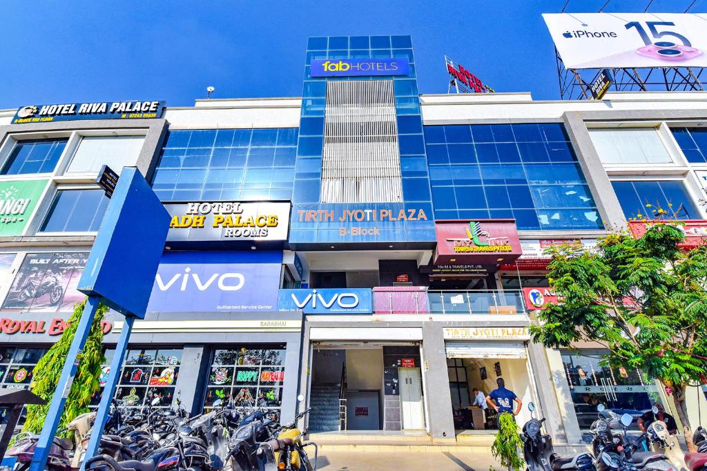 a building with motorcycles parked in front of it at FabHotel Avadh Palace in Ahmedabad