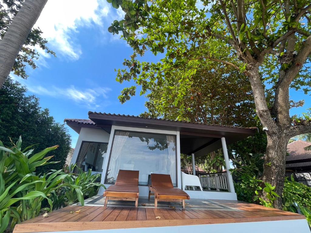 two chairs on a deck in front of a house at Evergreen Resort in Chaweng