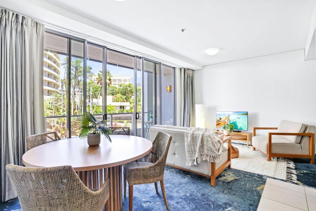 a living room with a table and chairs at 219 Harbour Lights with Ocean Views in Cairns