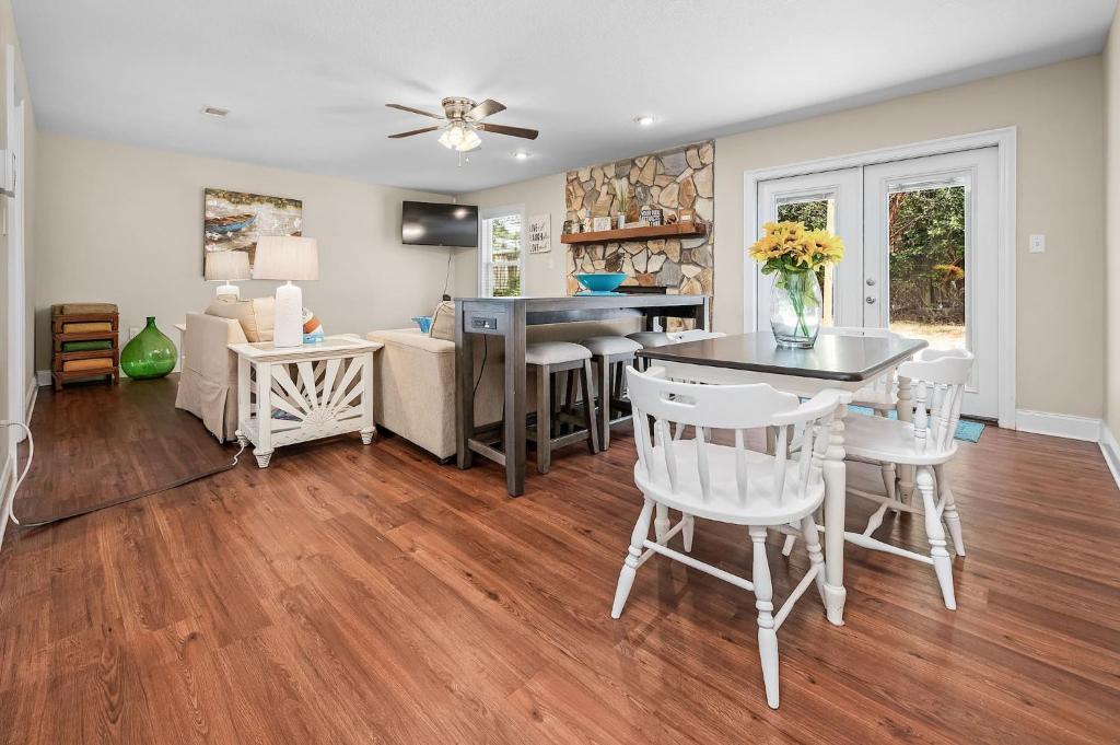 a kitchen and living room with a table and chairs at Niceville Dream Home Sleeps 13 in Niceville