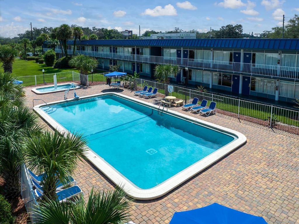 a large swimming pool in front of a building at Days Inn by Wyndham Orlando Downtown in Orlando