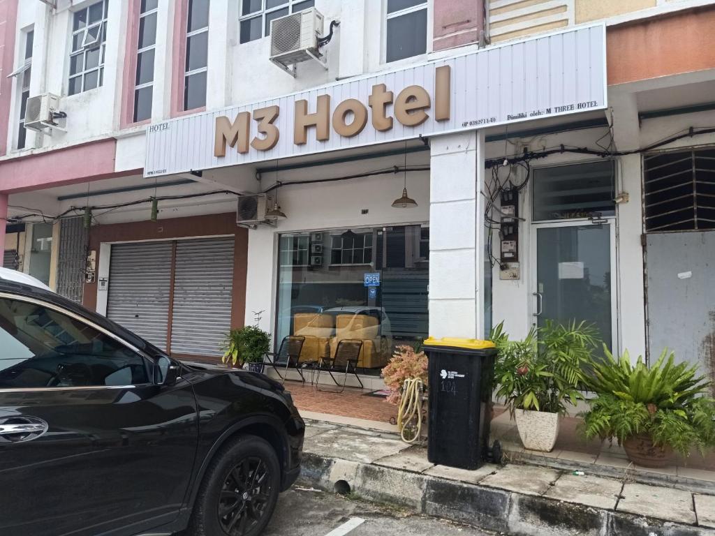 a car parked in front of a ms hotel at M Three Hotel by SECOMS in Kampong Batu Tiga