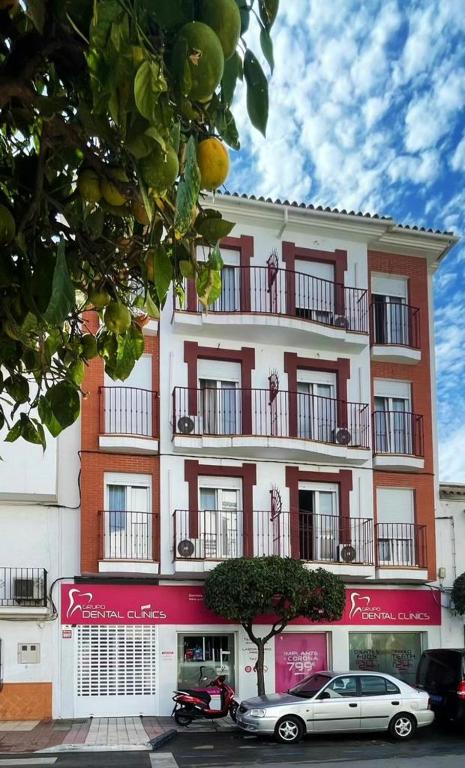 a building with a car parked in front of it at Casa Rosa Nova in Marbella