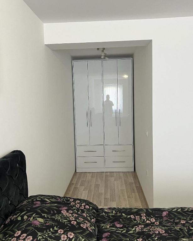a room with a glass door with a bed in it at Apartman Stil in Bugojno