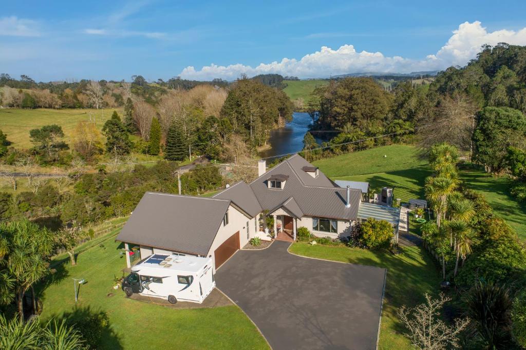 an aerial view of a house with a river at McLaren Lake View in Tauranga