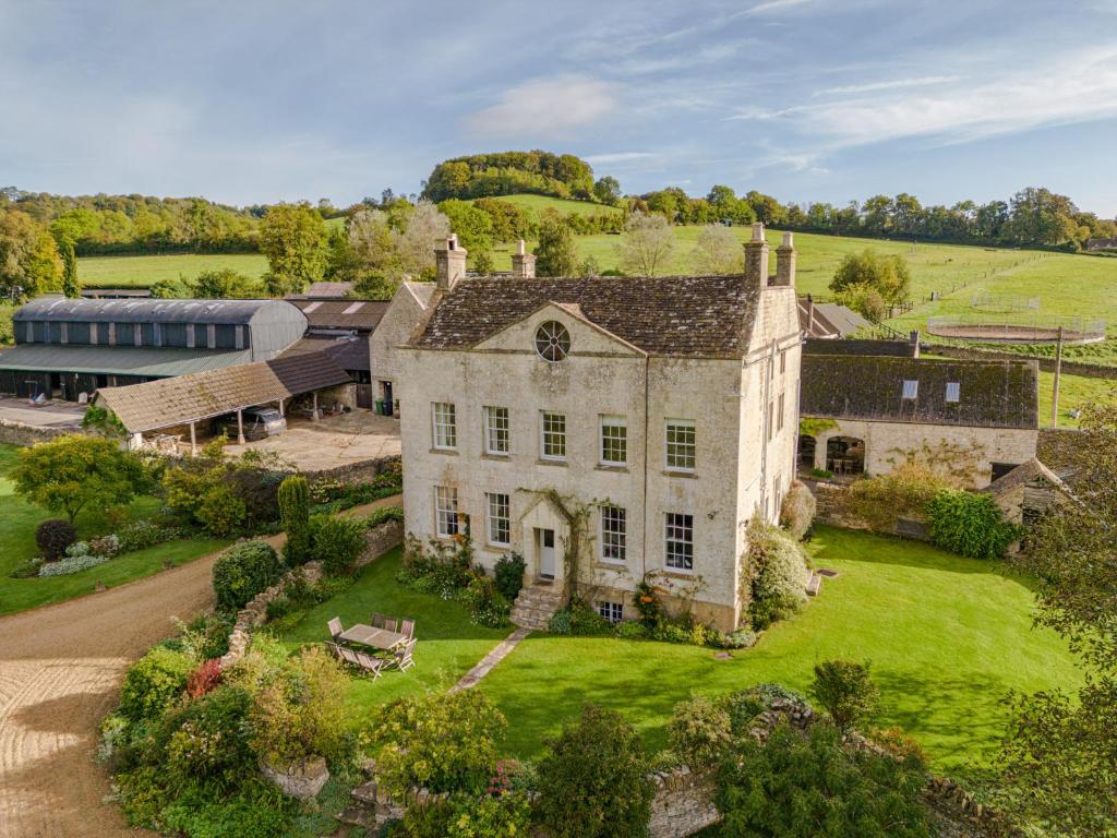 an aerial view of a large stone house with green grass at Down Farm Manor in Stroud