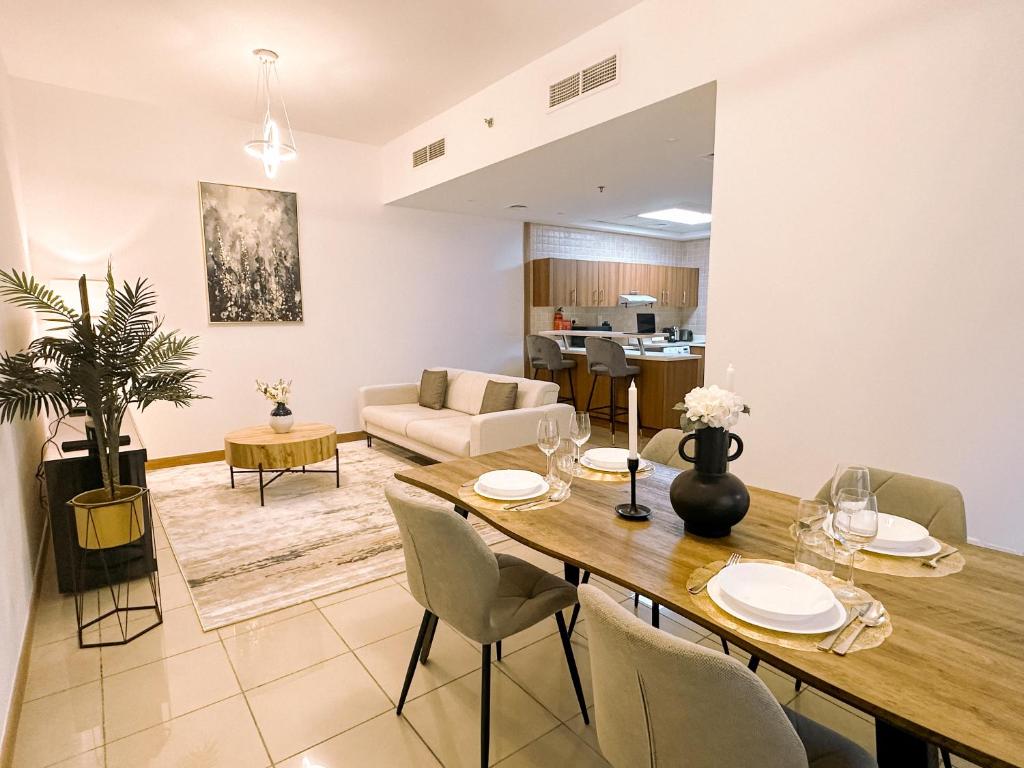 a dining room and living room with a table and chairs at Brand new apartment in Dubai Marina 47th floor in Dubai