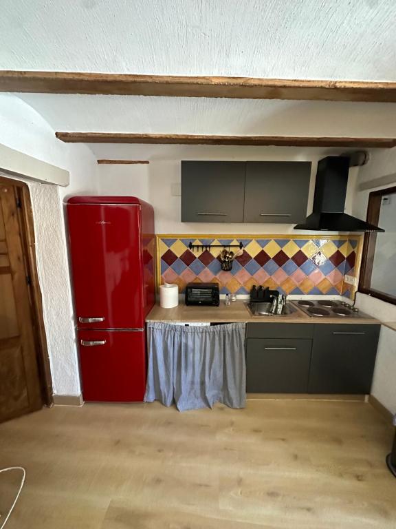 a kitchen with a red refrigerator in a room at Casa Cueva Luna in Orce