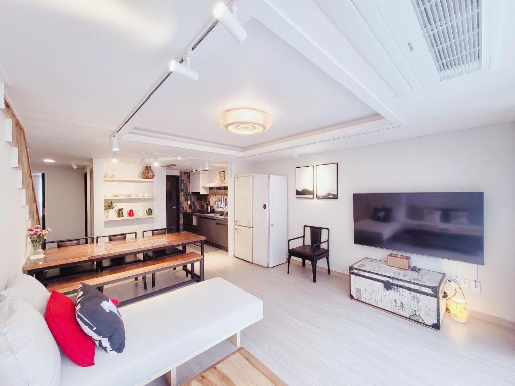 a living room with a white couch and a table at White Casa in Seogwipo