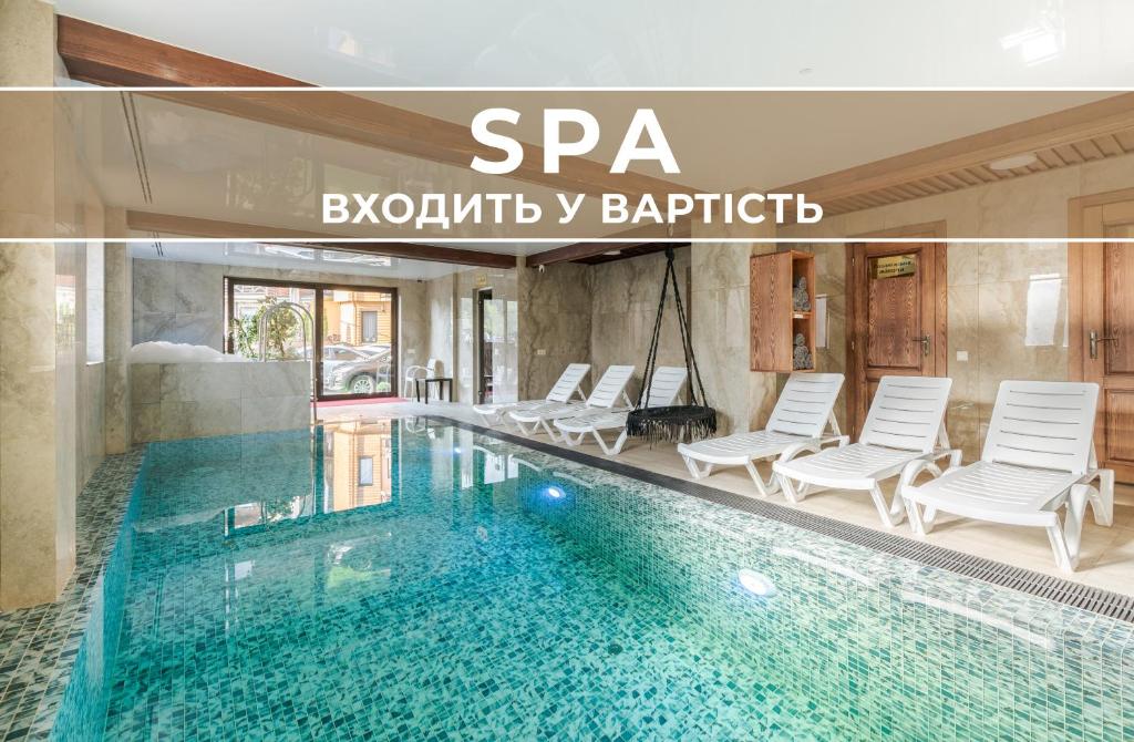 a swimming pool with chairs and a spa in a building at Villa Morishka & SPA in Bukovel