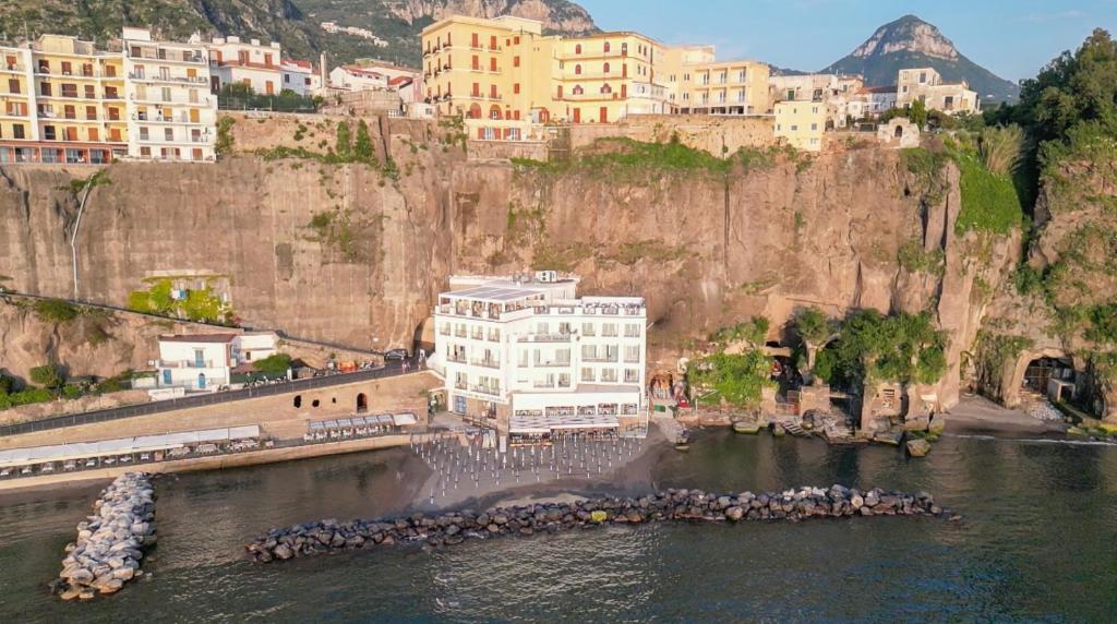 a building in the water next to a city at Hotel Giosue' a mare in Meta
