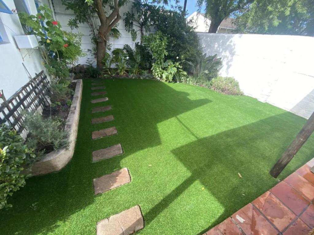 a garden with green grass and a pathway at Rondebosch loft in Cape Town