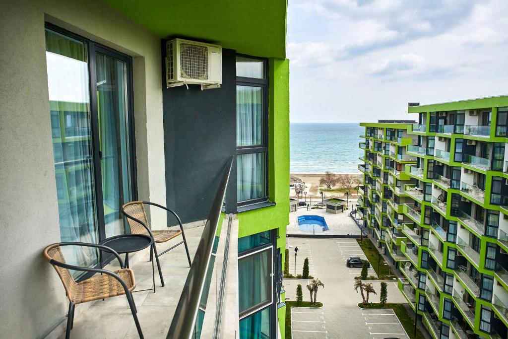 a balcony with chairs and a view of the ocean at Apartamente Indigo Alezzi Beach Pool & Spa in Mamaia Sat/Năvodari