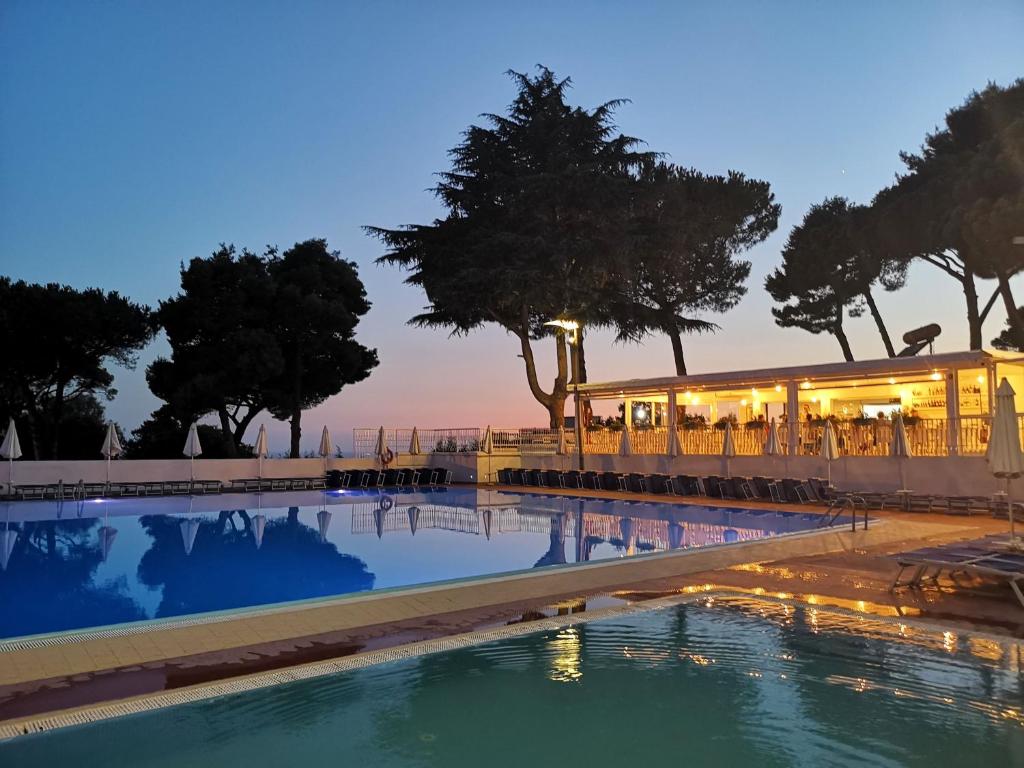 una piscina con ristorante sullo sfondo di Rosina apartment a Torre del Greco
