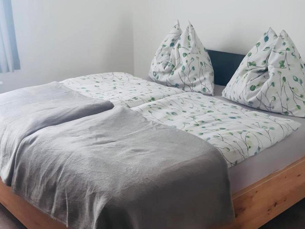 a bed with a blanket and pillows on it at Beautiful apartment in K ttmannsdorf with terrace in Köttmannsdorf