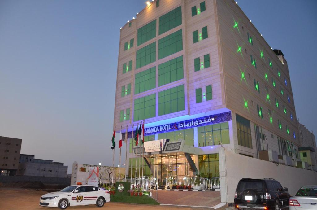 a building with cars parked in front of it at جولدن أرمادا جيزان Golden Armada Hotel in Jazan