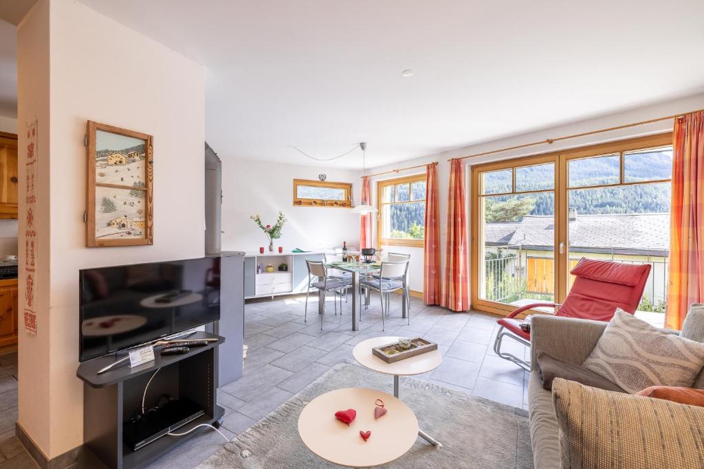 a living room with a couch and a table at Trü-Sura Nr. 7 in Scuol