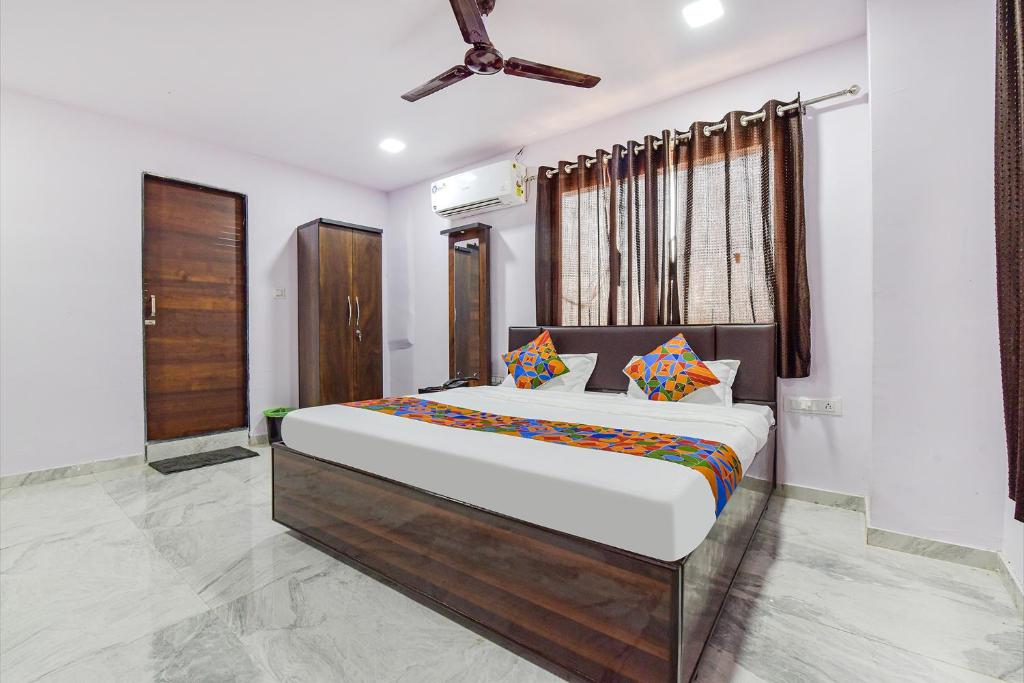 a bedroom with a large bed in a room at FabHotel Vishwa Palace in Ahmedabad