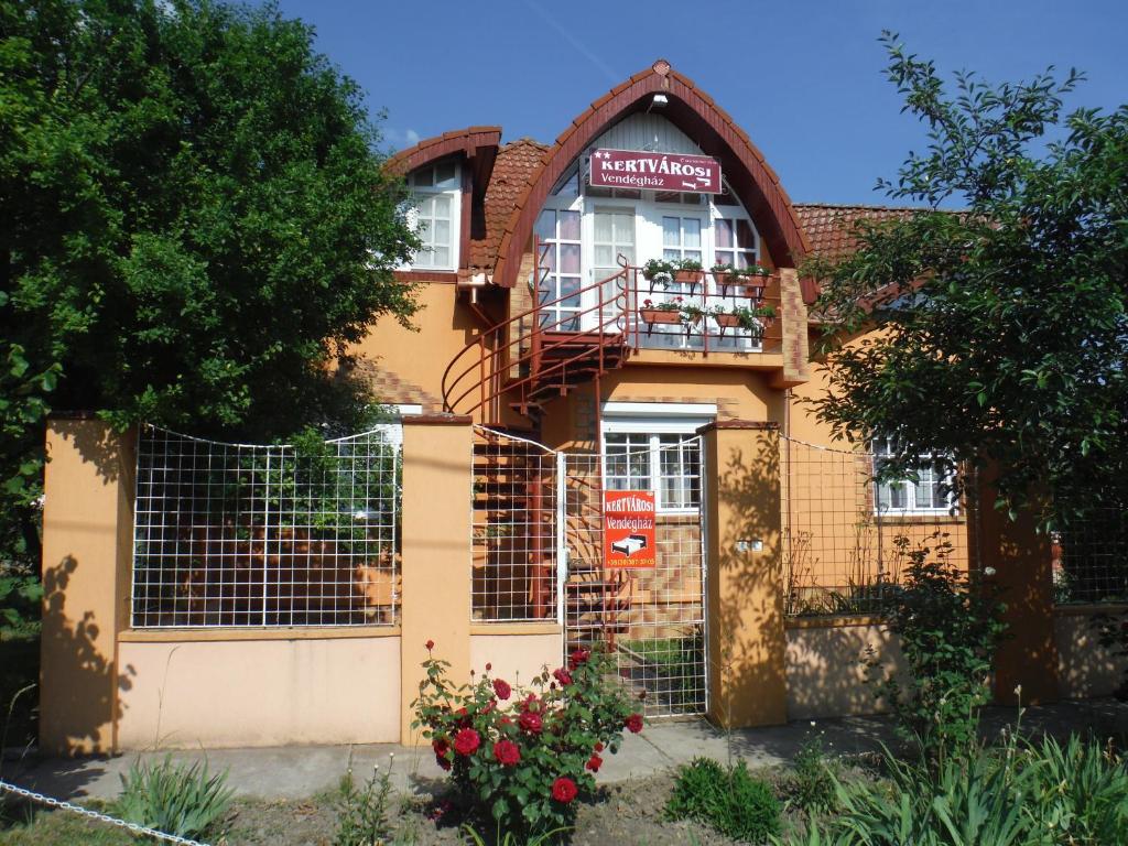 a building with a sign on the front of it at Kertvárosi Vendégház in Orosháza