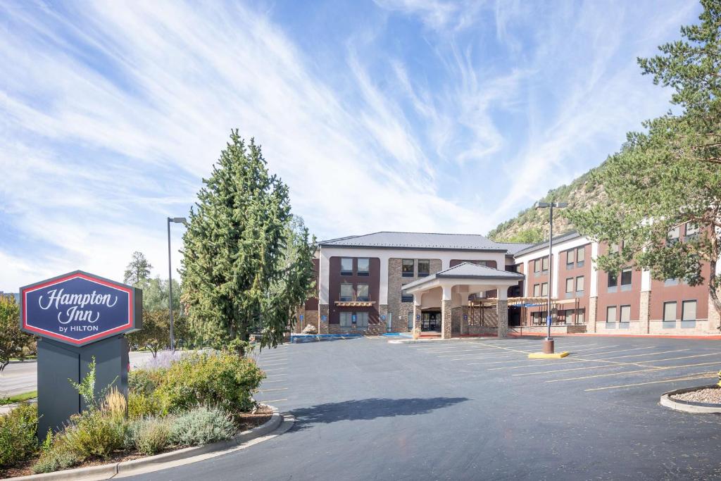 a sign in a parking lot in front of a building at Hampton Inn Durango in Durango