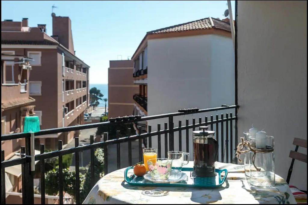 a table on a balcony with a view of a city at Sunny holidays in Santa Pola in Santa Pola