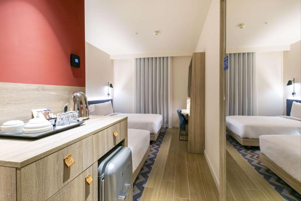 A bed or beds in a room at Hampton By Hilton Alcobendas Madrid