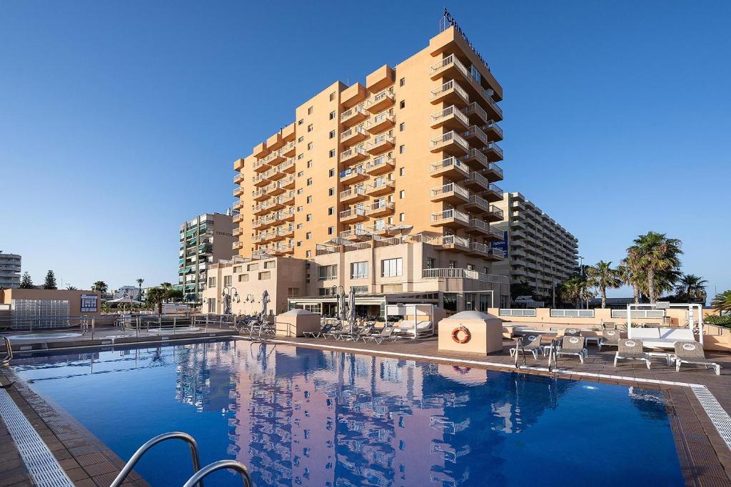 una gran piscina frente a un edificio en Poseidon La Manga Hotel & Spa - Designed for Adults, en La Manga del Mar Menor