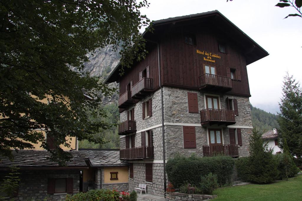 a large building with balconies on the side of it at Hotel Dei Camosci in Courmayeur