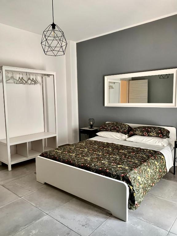 a bedroom with a large bed and a mirror at Casa Citro in Salerno