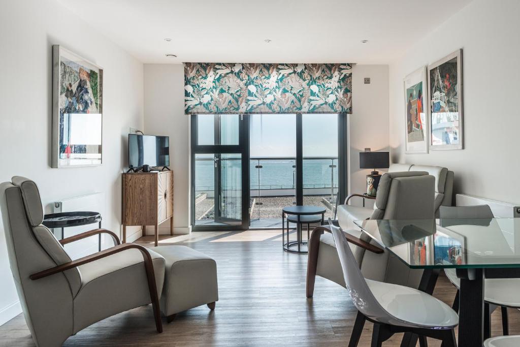 a living room with a view of the ocean at Beachside: New two bedroom apartment with parking in Kent