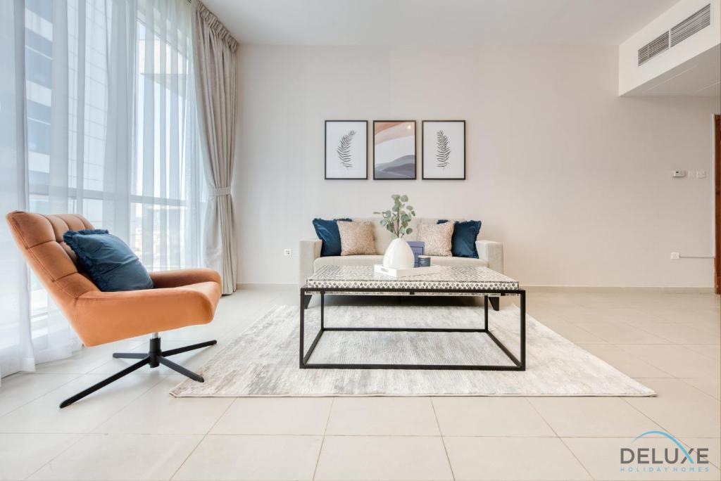 a living room with a couch and a coffee table at Serene 1BR at Park Terrace Silicon Oasis by Deluxe Holiday Homes in Dubai