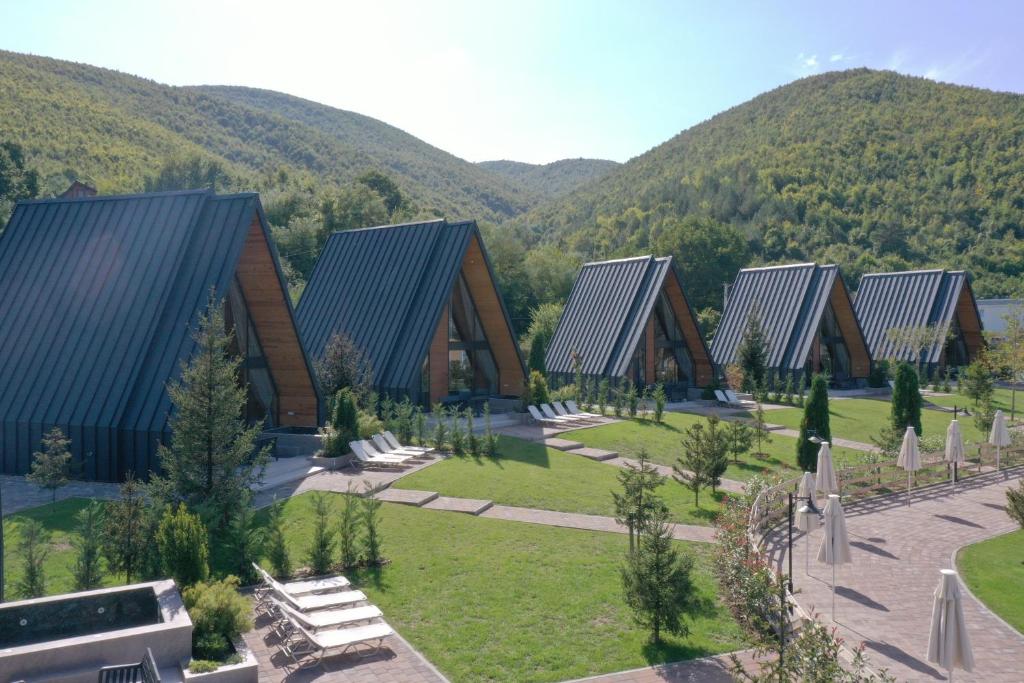 a group of buildings with mountains in the background at Freskia Resort in Ferizaj